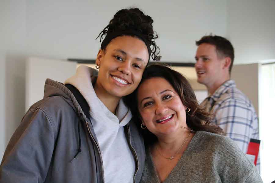 Two friends smiling together after a Sunday service