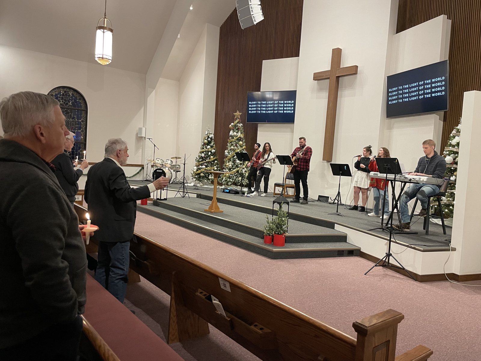 Worshipers holding candles during the Christmas candlelight service