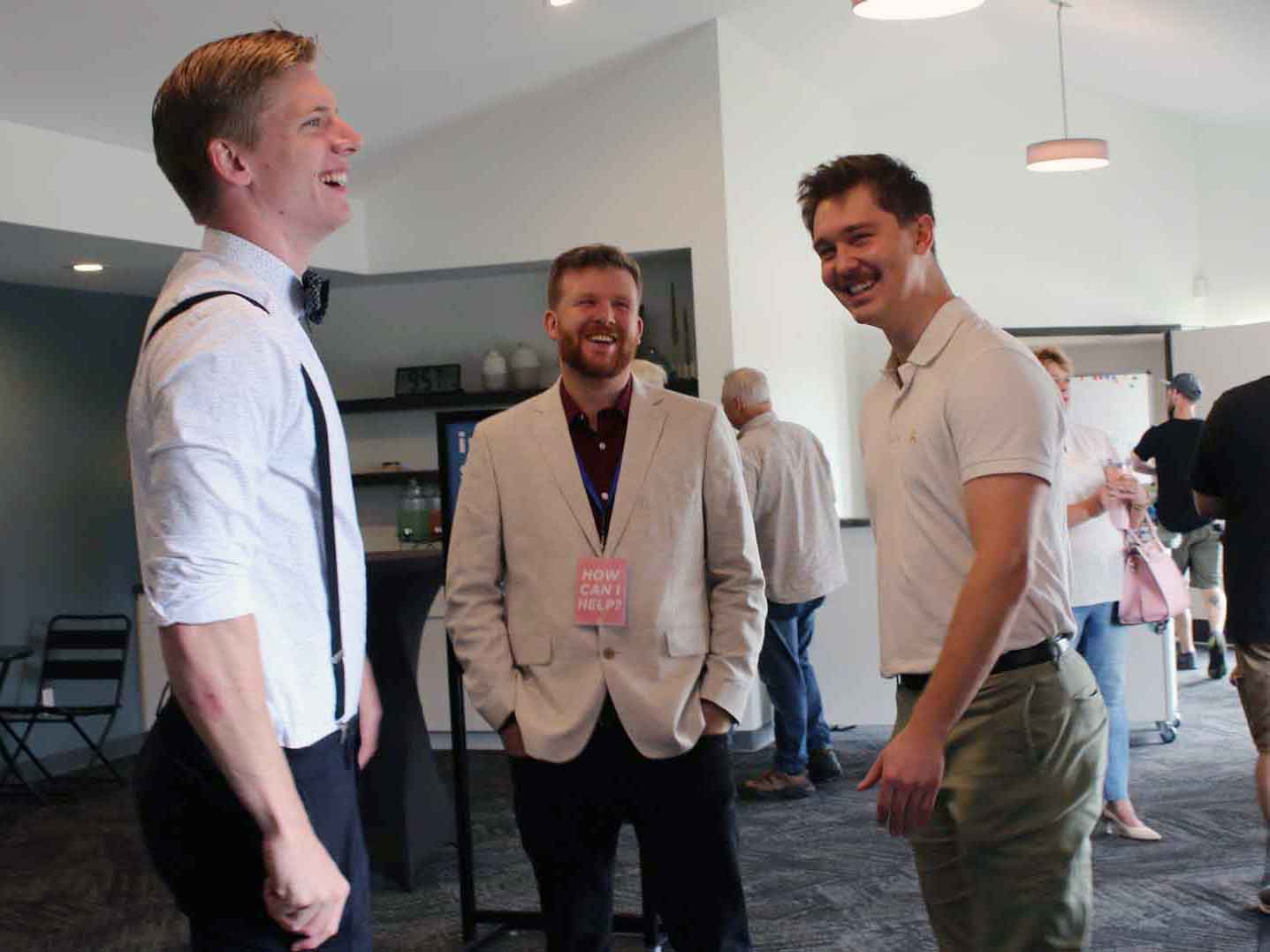 Friends laughing together in the church lobby